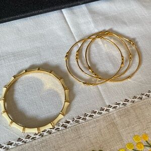 Gold and enamel bangles with diamond accents by Stella & Dot.